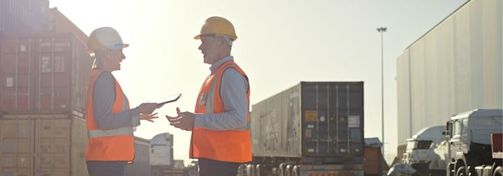 two supply chain workers talking