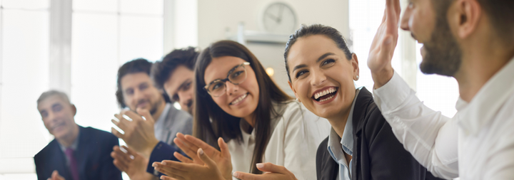 group of happy people looking at their leader