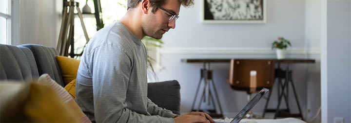 male ccu online student studying at home