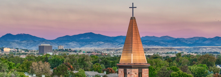 armstrong center steeple set against picturesque mountains