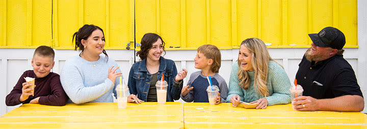 smiling happy family sitting together laughing