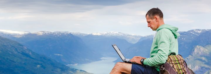 A man is working remotely while on vacation.