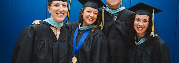 Adult students are celebrating at their college commencement.