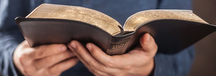 A man holding the Holy Bible in his hands