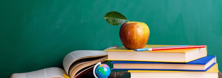 an apple on top of books