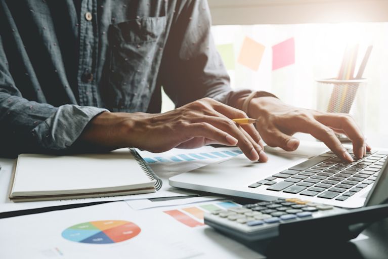 A professional accountant is working at his desk.