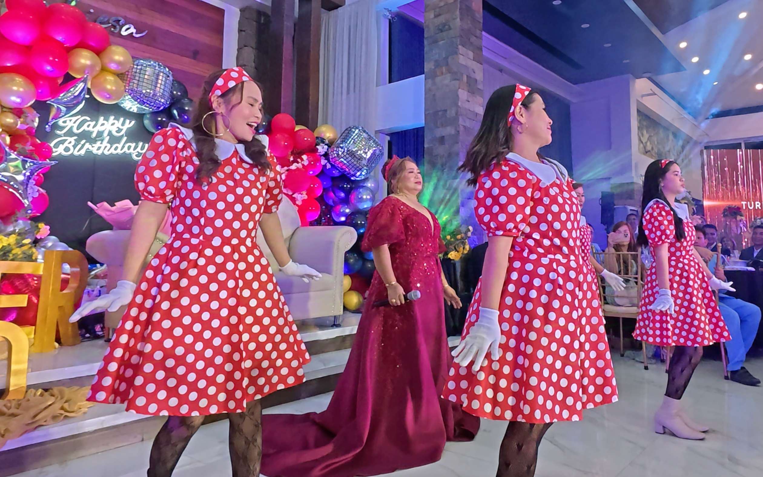 Hon. Ester Marasigan performing in a maroon gown with her sisters and nieces as backup dancers at Trabiesa, Tagaytay