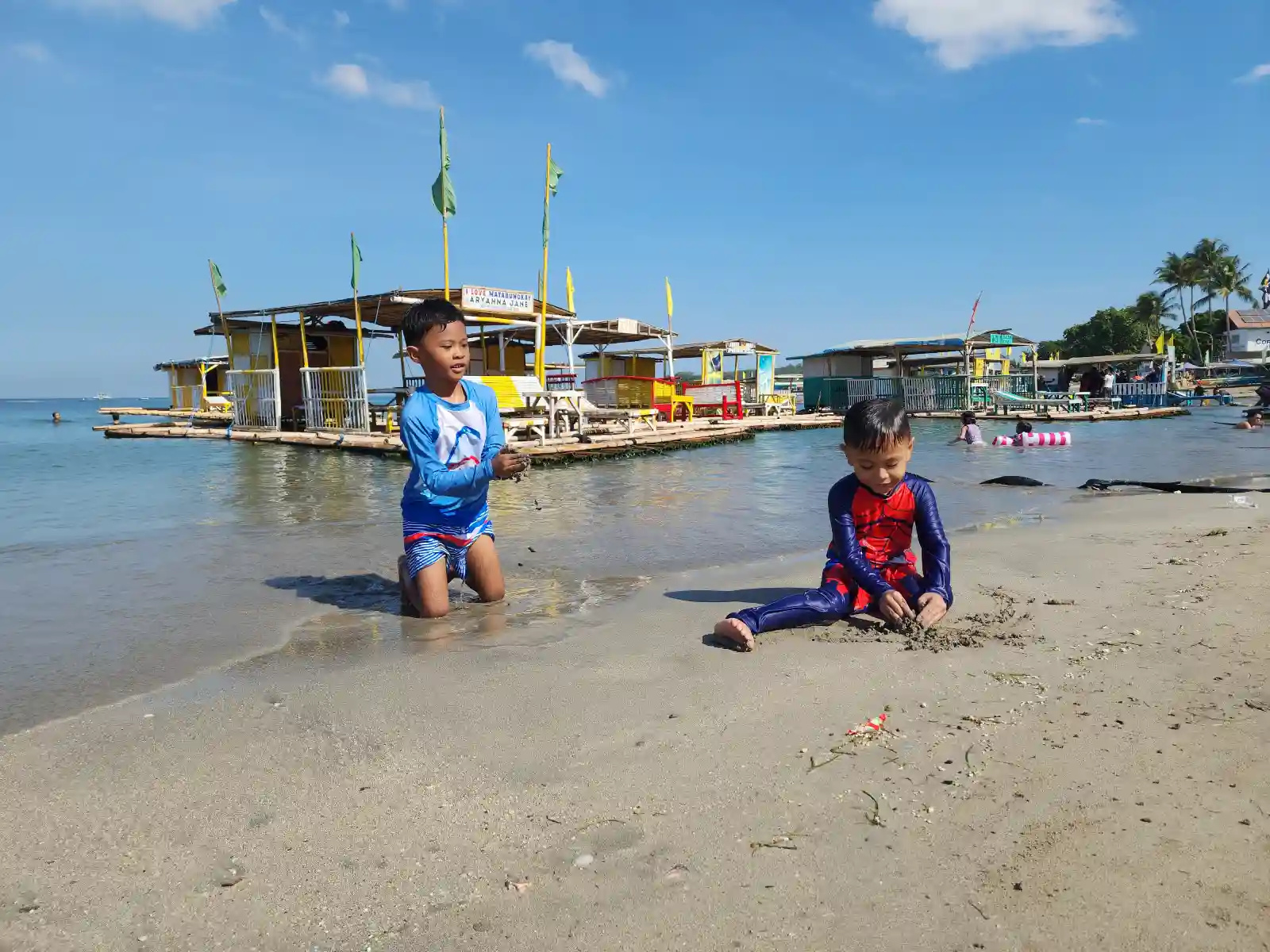 Children swimming and playing in calm clear water at the shore of Alfresco Beach Resort in Matabungkay Lian Batangas