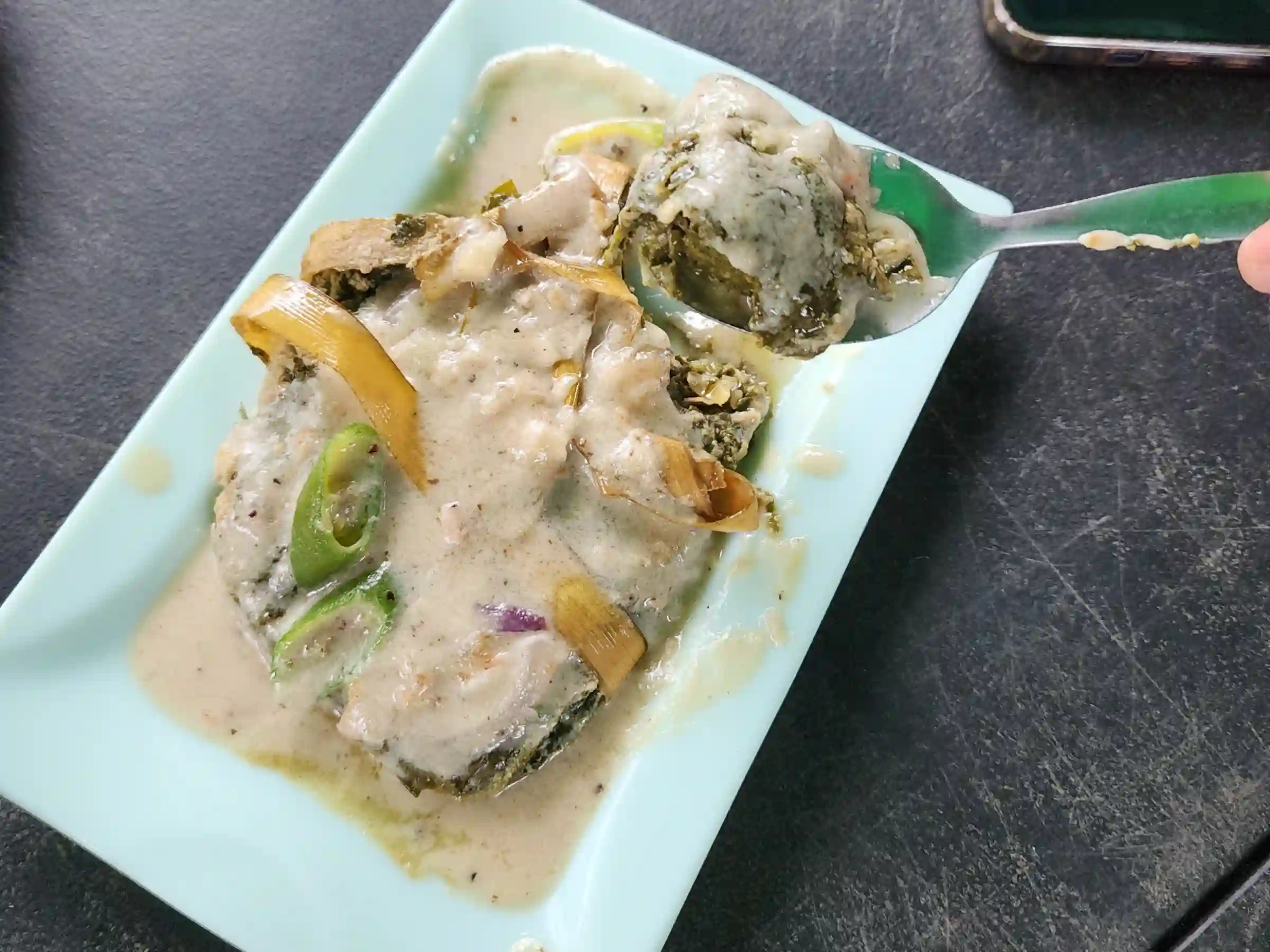A plate of laing na gabi in thick coconut milk with green chili and lemongrass at a carinderia near Cagsawa Ruins in Daraga Albay