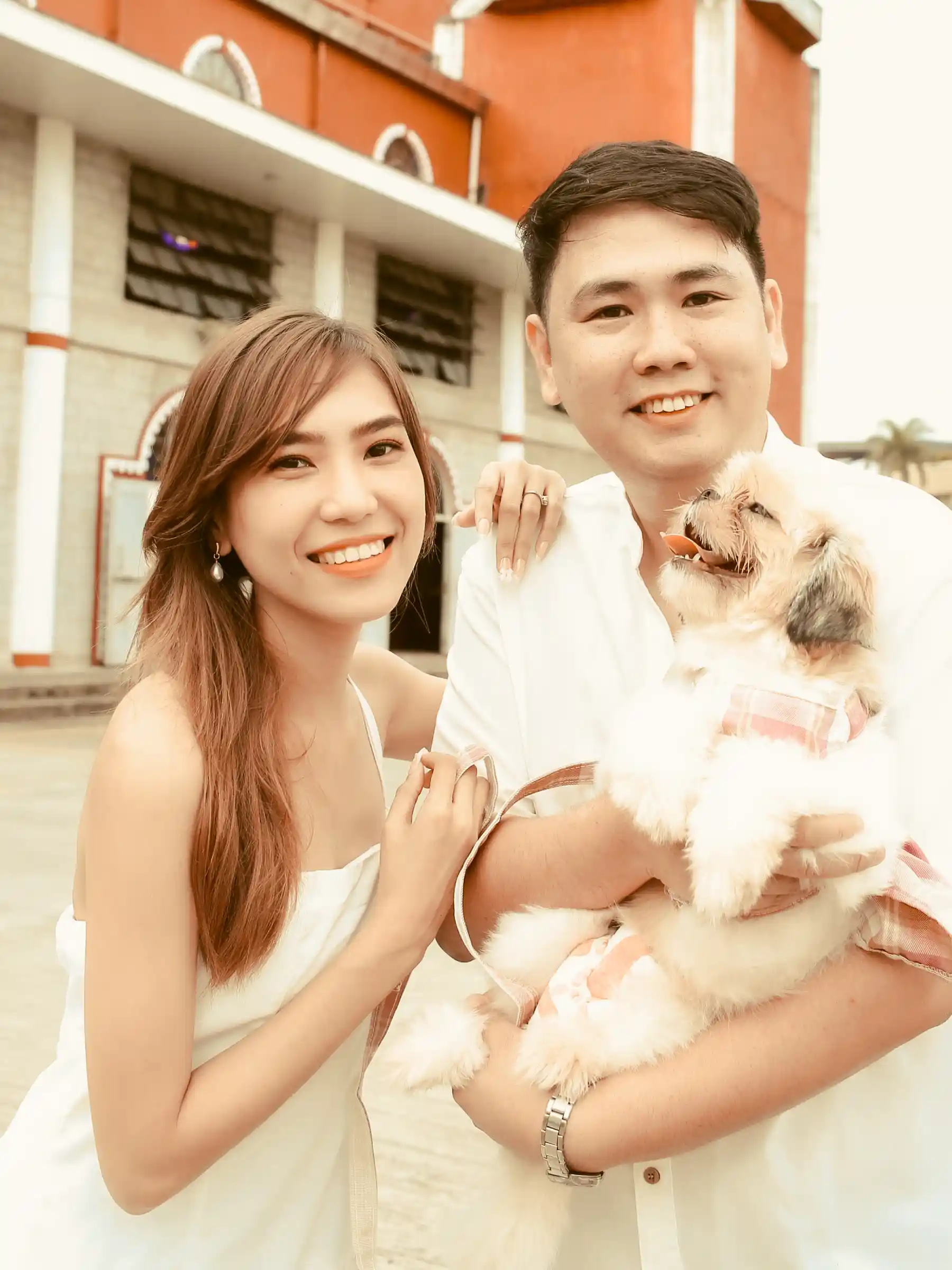 Judy Ann and Ryan Lester Celorico with their small dog in front of Sto. Nino de Cebu Parish in Southwoods Alabang