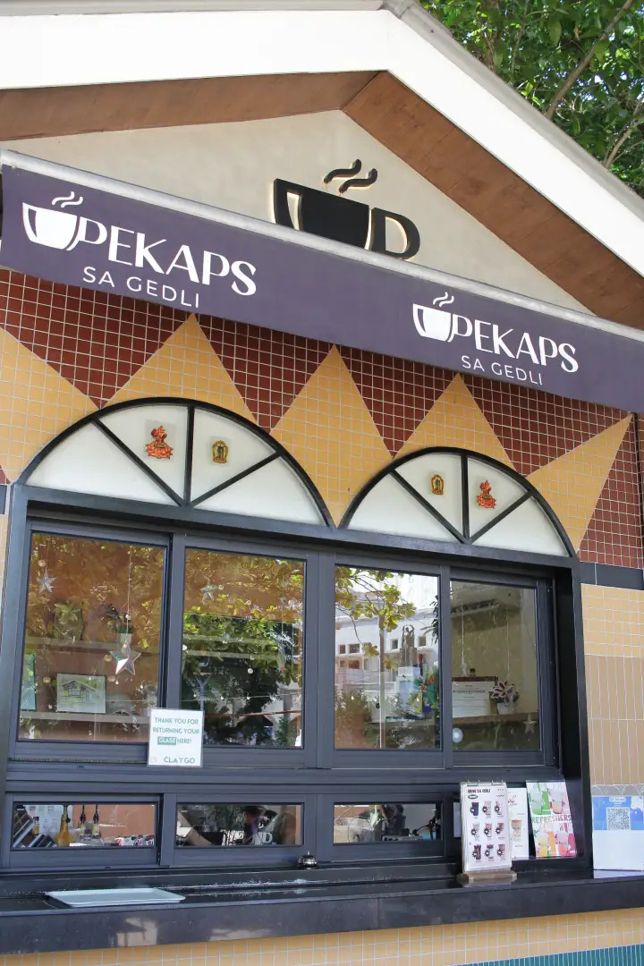 Purple Pekaps sa Gedli signage on a tiled coffee shop facade with arched windows in Manila
