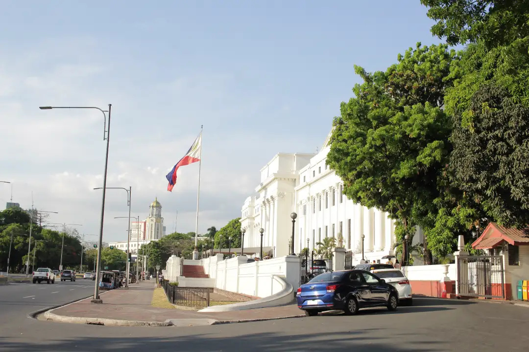 National Museum of Fine Arts facade along Padre Burgos Avenue with the Philippine flag in Ermita Manila