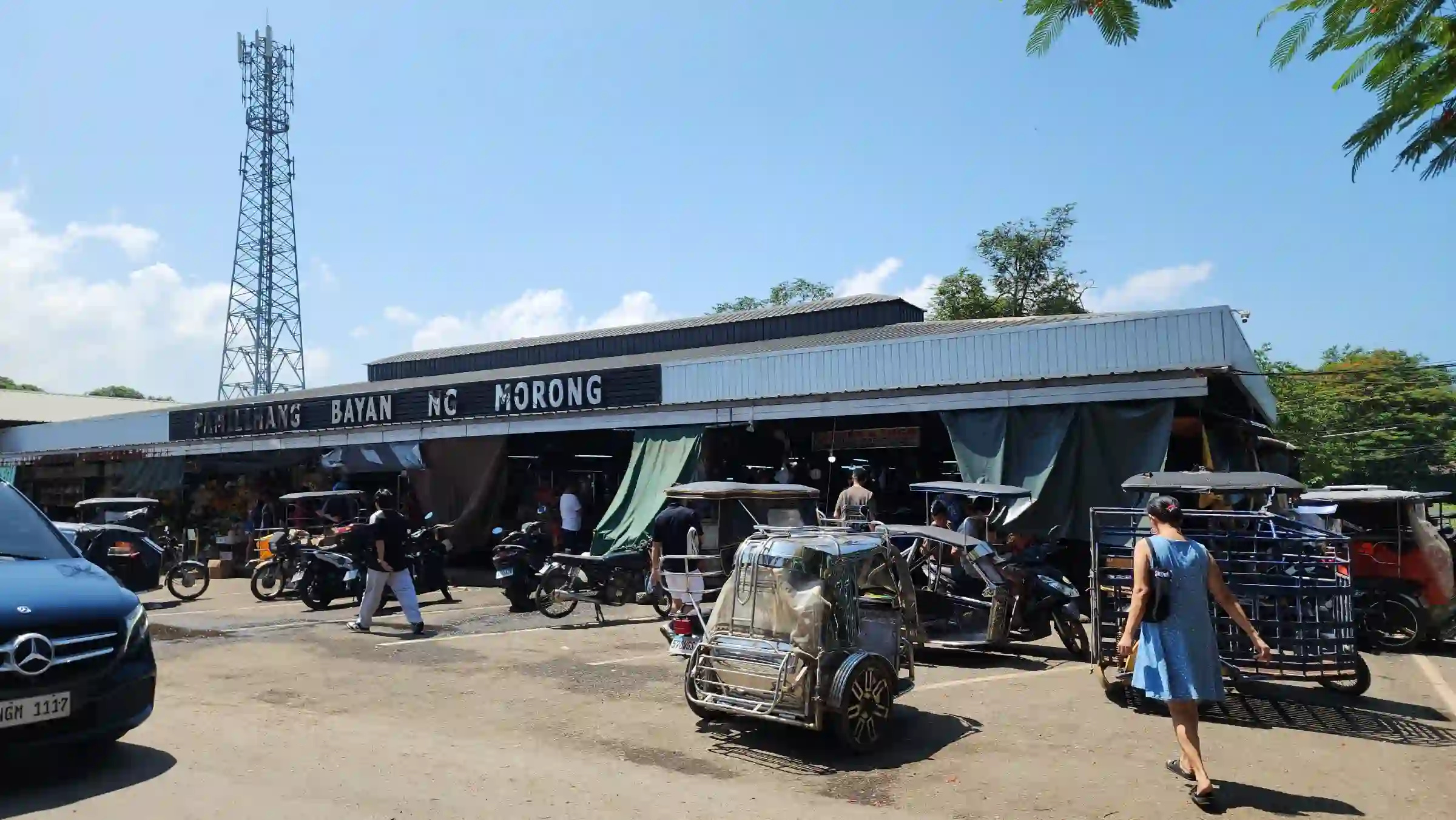 Exterior of Pamilihang Bayan ng Morong public market with tricycles and shoppers in Morong Bataan