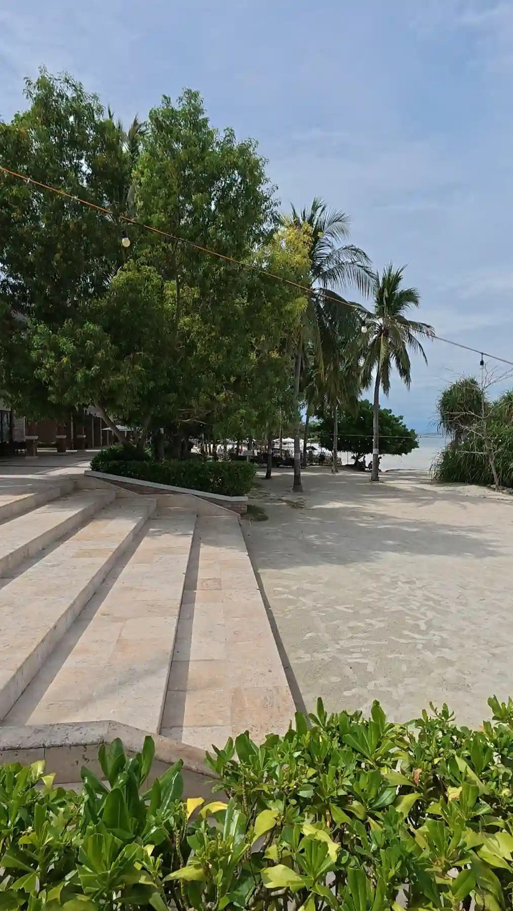 Stone steps leading down from Moadto Strip toward the sand of Doljo Beach in Panglao, Bohol