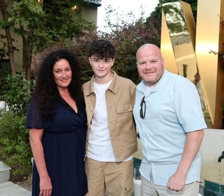 Actor Owen Cooper posing with his mother Noreen and father Andy Cooper at a red carpet event