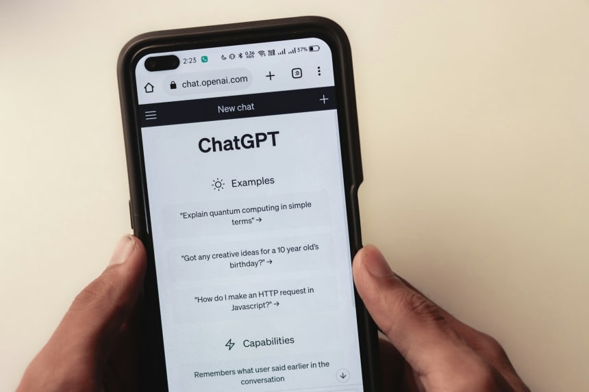 Hands holding a smartphone with ChatGPT open in the browser