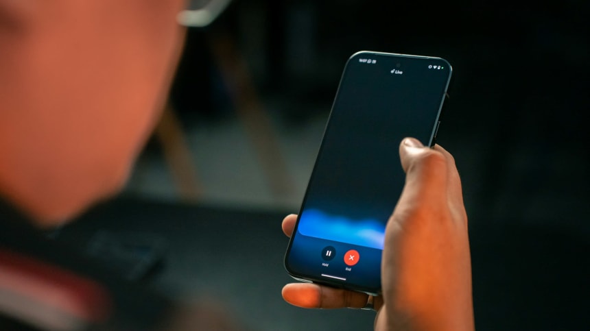 Person holding a phone during a Gemini Live voice conversation