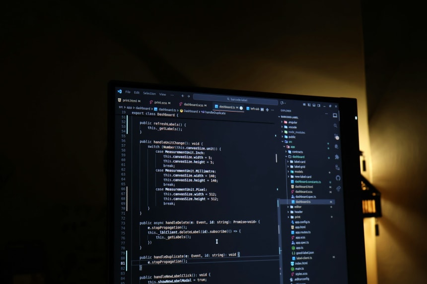 Code editor with a TypeScript file open on a monitor in a dark room