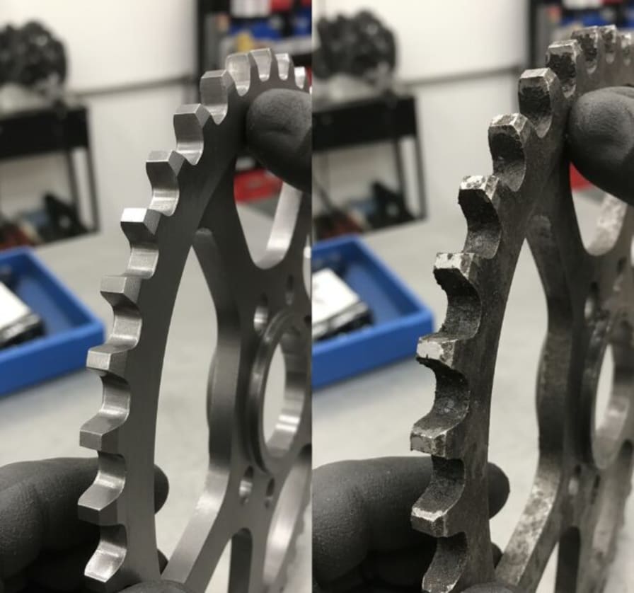 worn motorcycle sprocket shark-fin tooth profile close-up