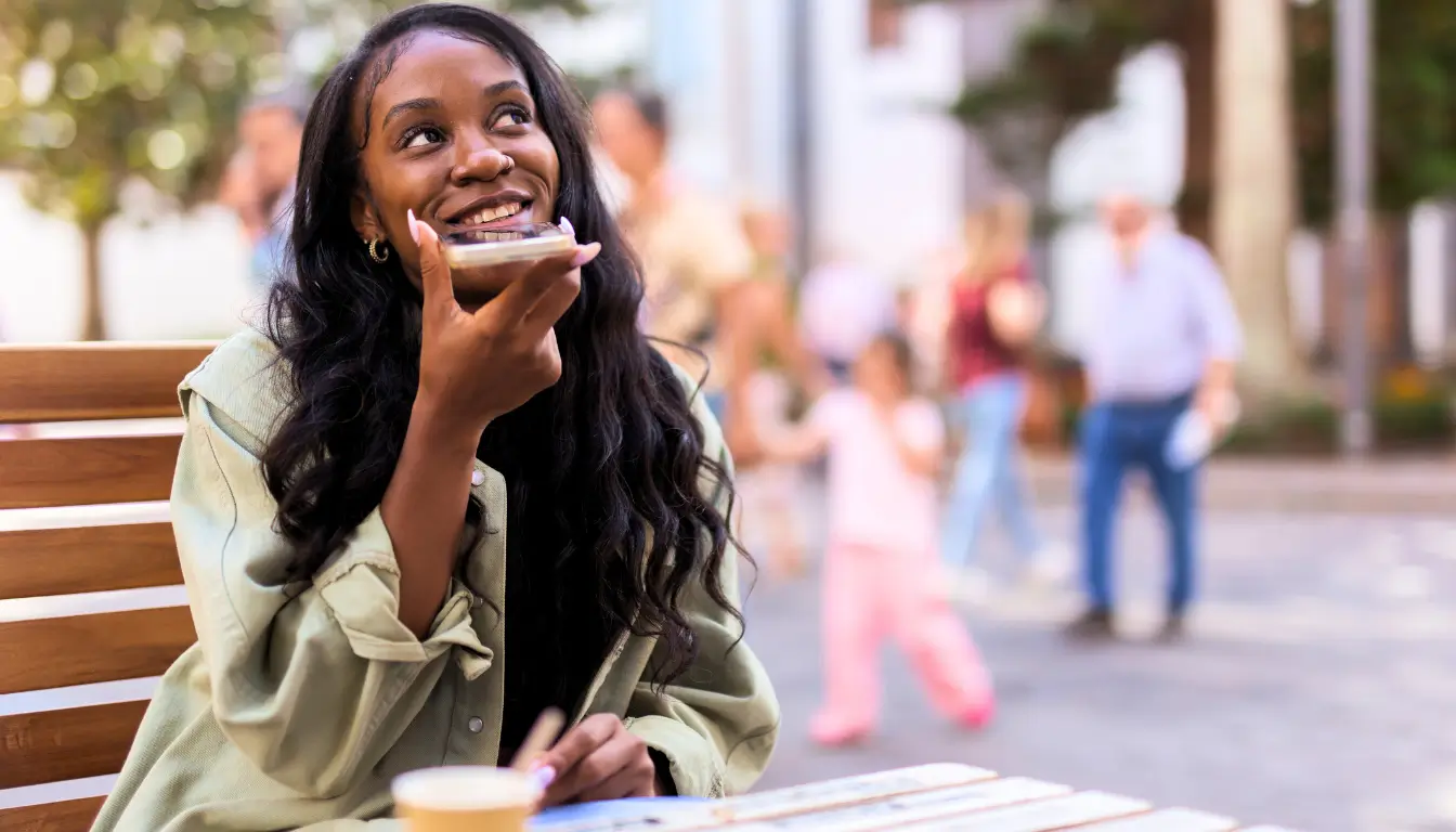A woman recording a voice message for her partner, sharing daily moments to stay connected in their long-distance relationship.