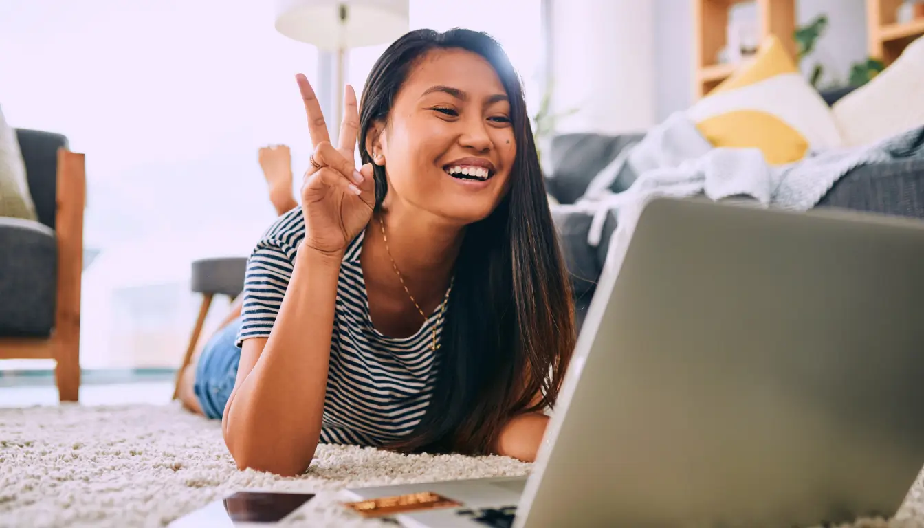  A woman on a video call, engaging in a weekly check-in to strengthen connection and create stability in her long-distance relationship.