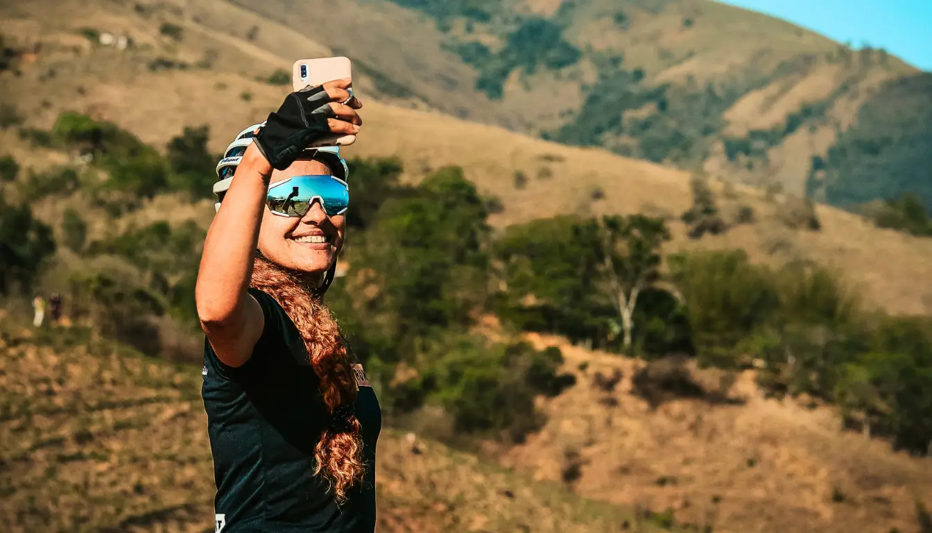 A woman taking a selfie outdoors to share with her partner, strengthening trust in their long-distance relationship. 