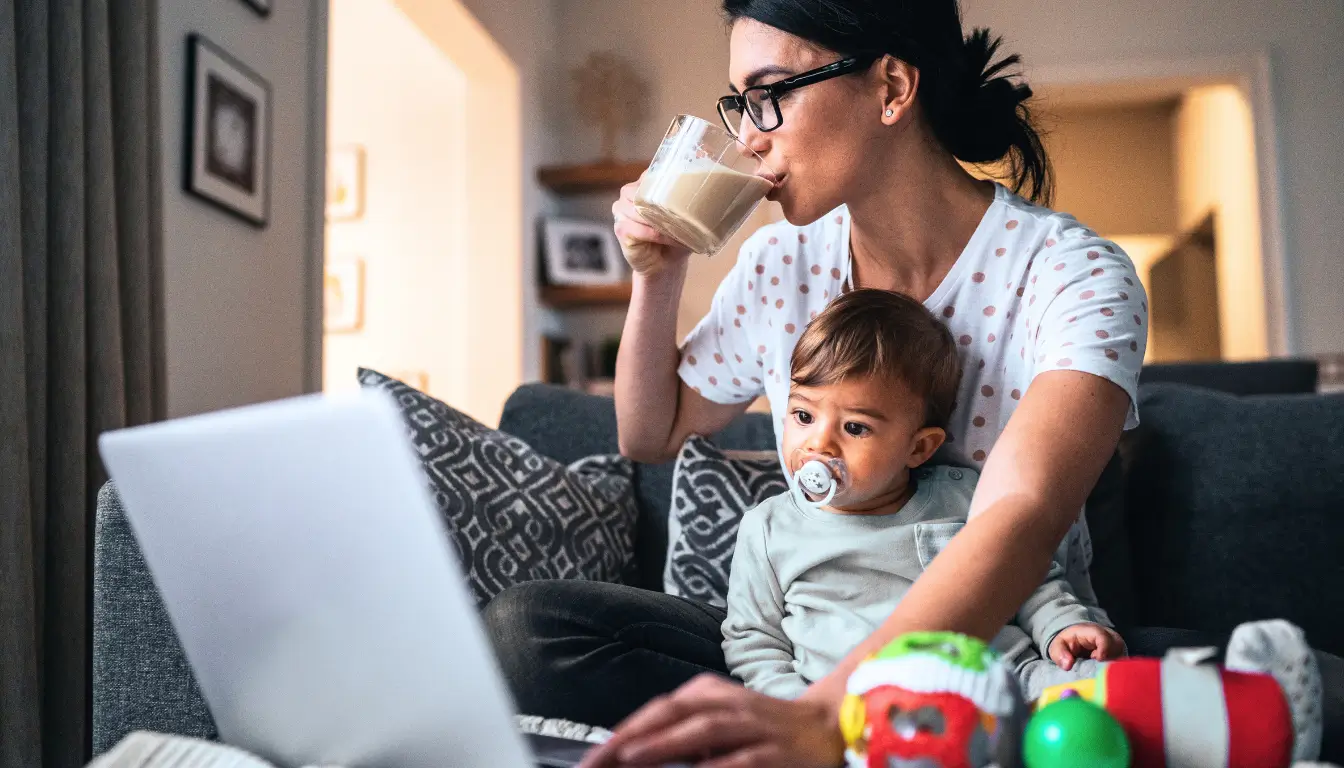 Expat mom working remotely while taking care of her child.