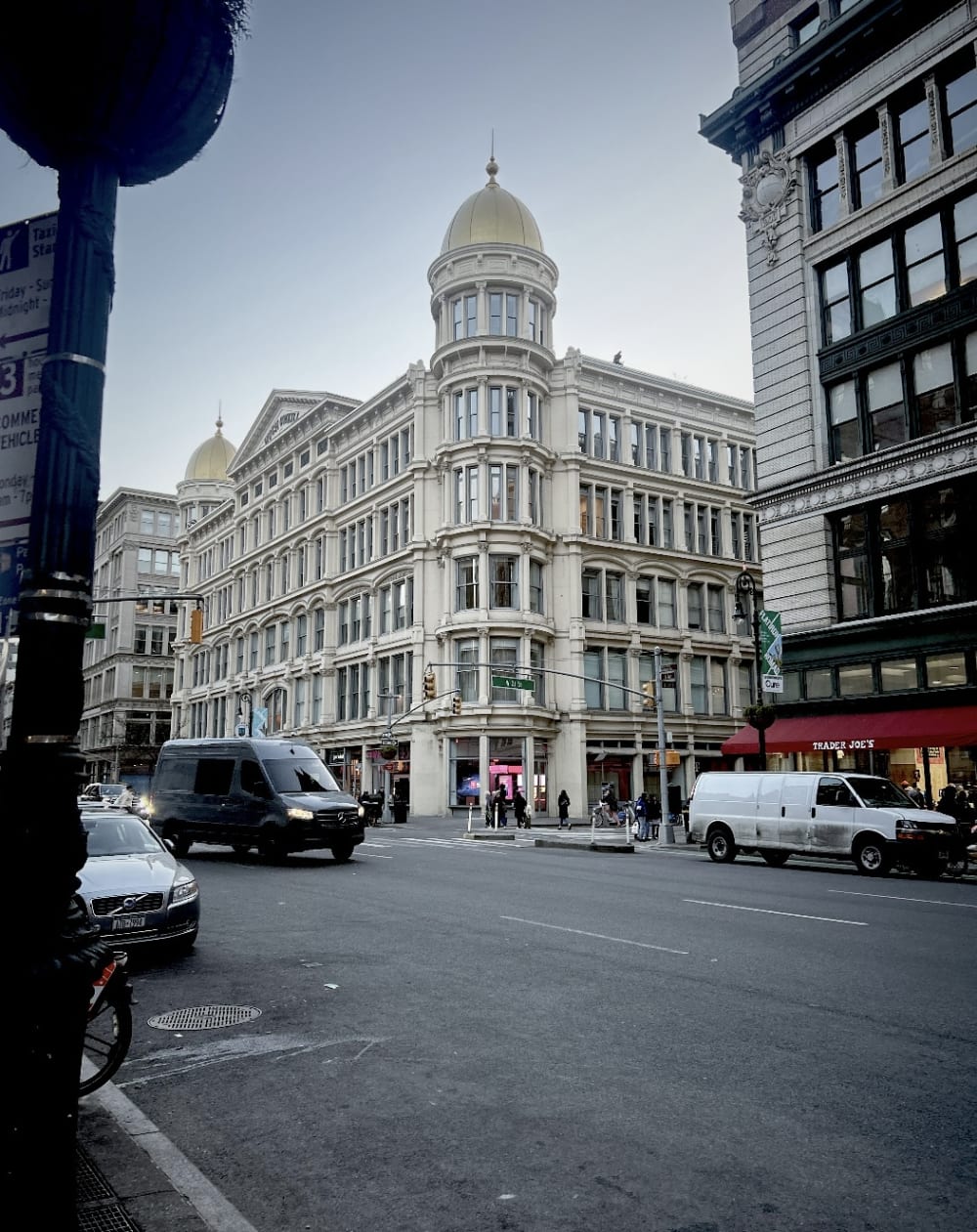 A picture of a white building on the corner of 23rd Street. 