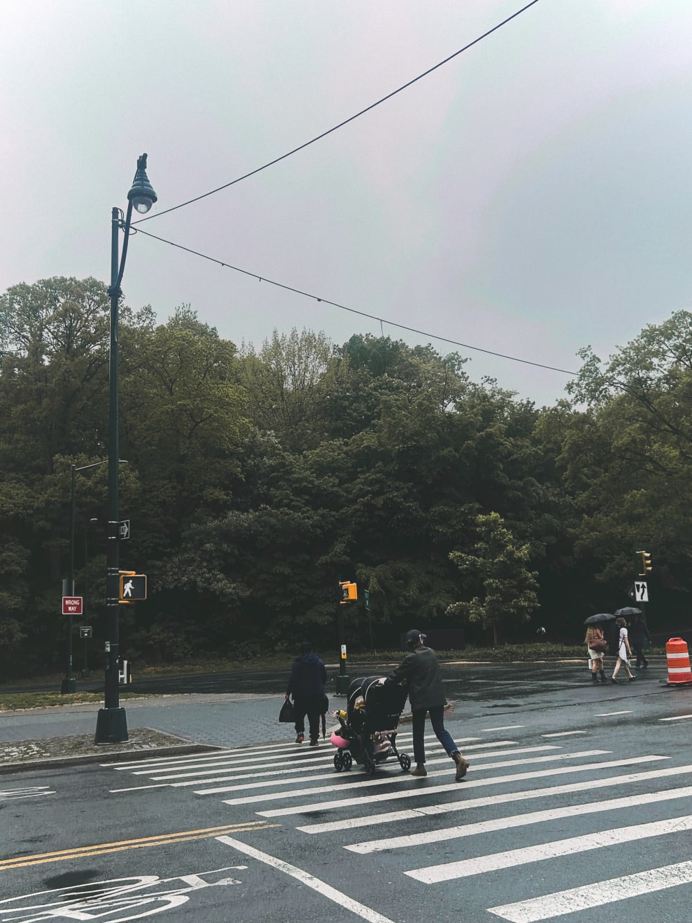 People walking in the street on a foggy day. 