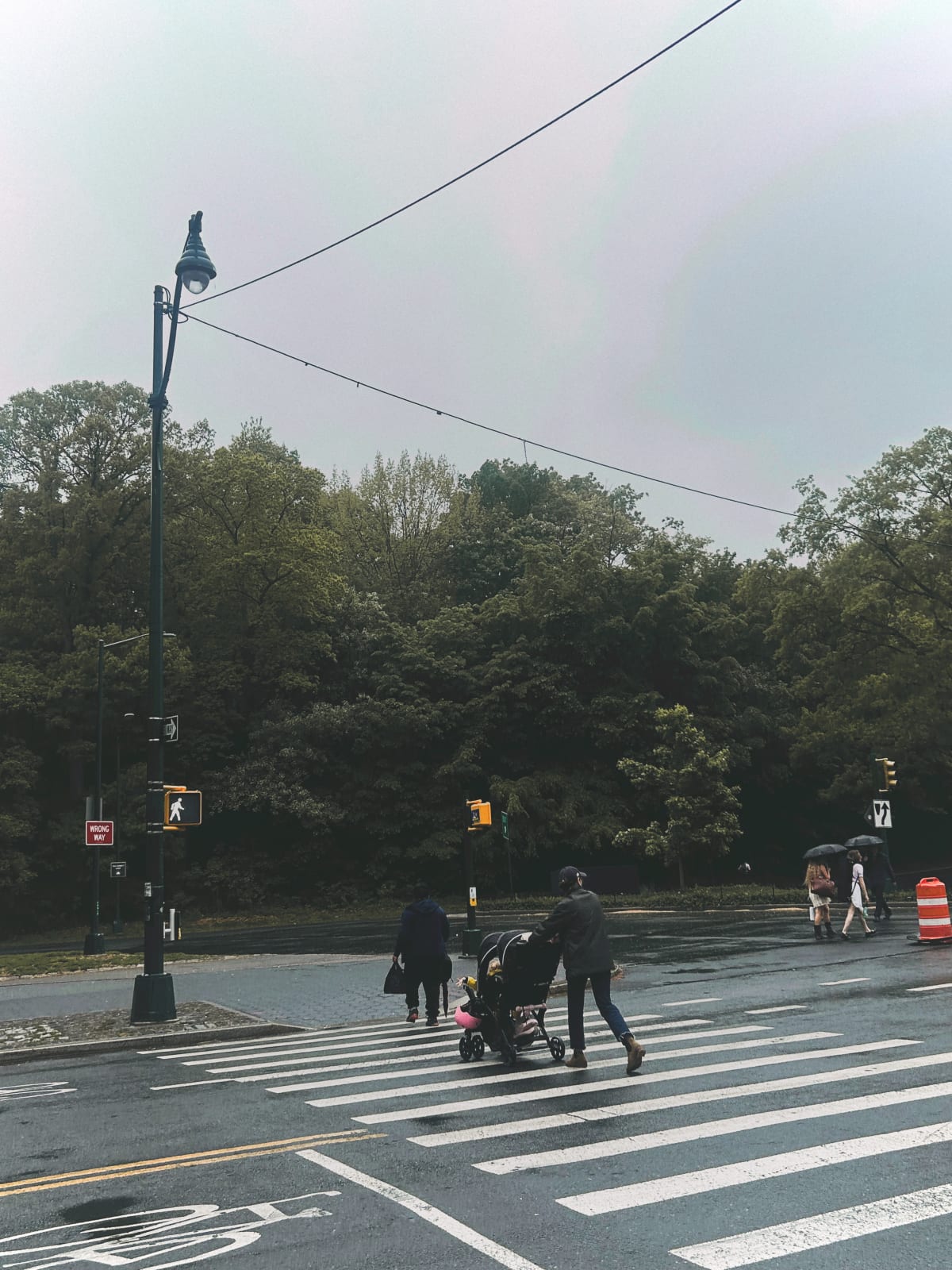 People walking in the street on a foggy day. 
