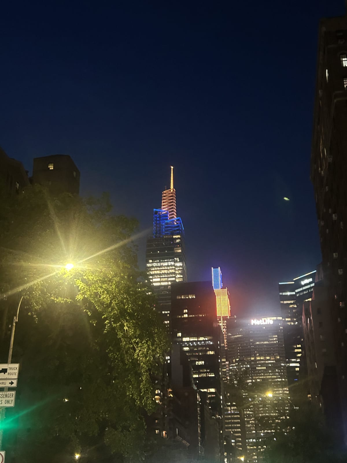 buildings in New York City that are lit up with the colors orange and blue