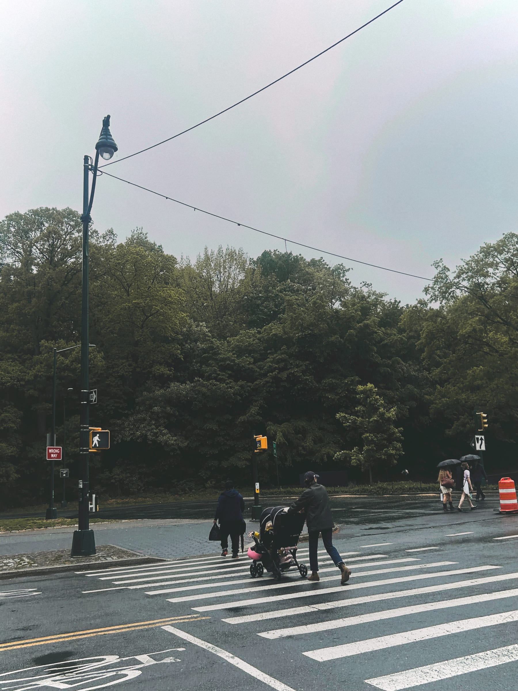 People walking in the street on a foggy day. 