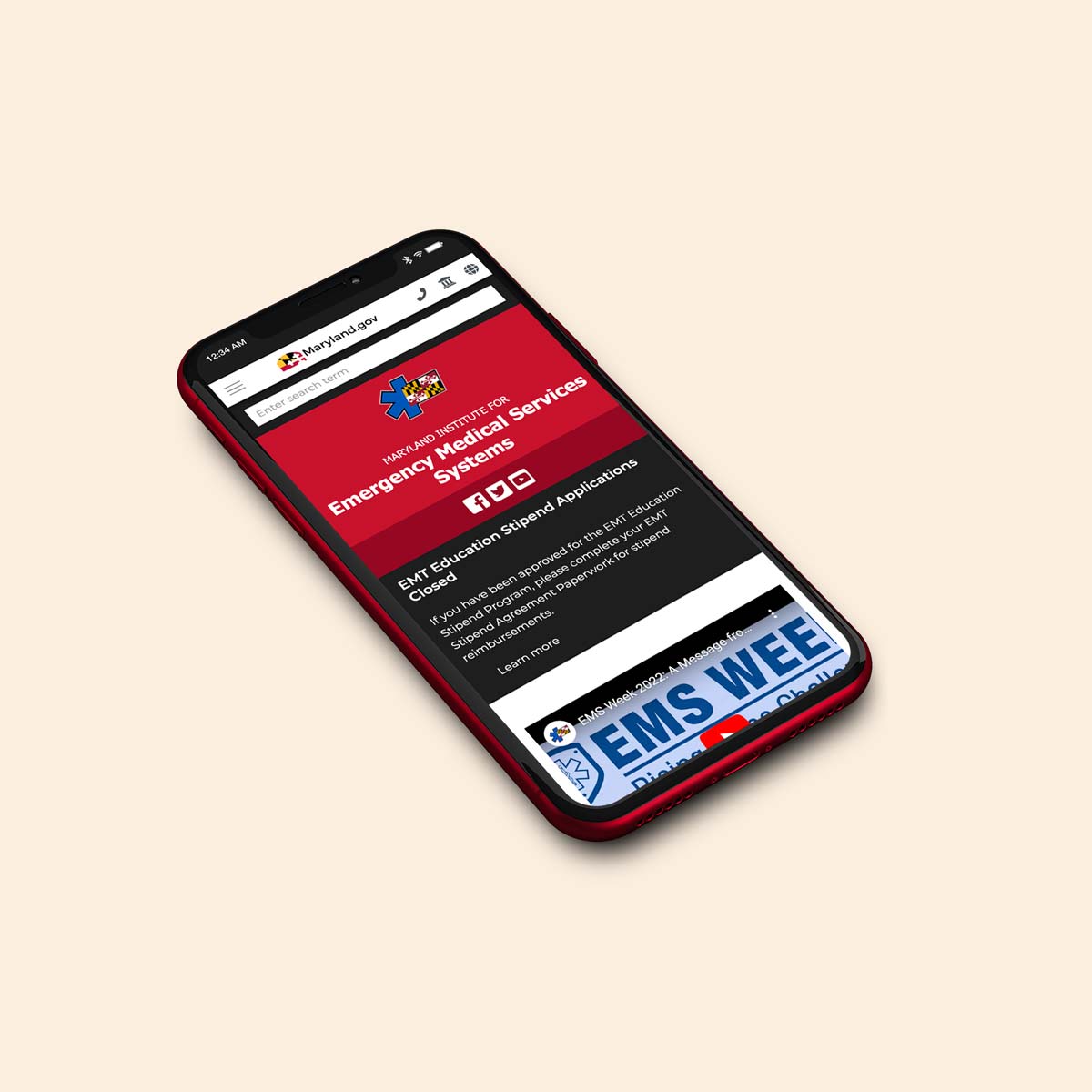 A red mobile phone with the Maryland EMS homepage on display