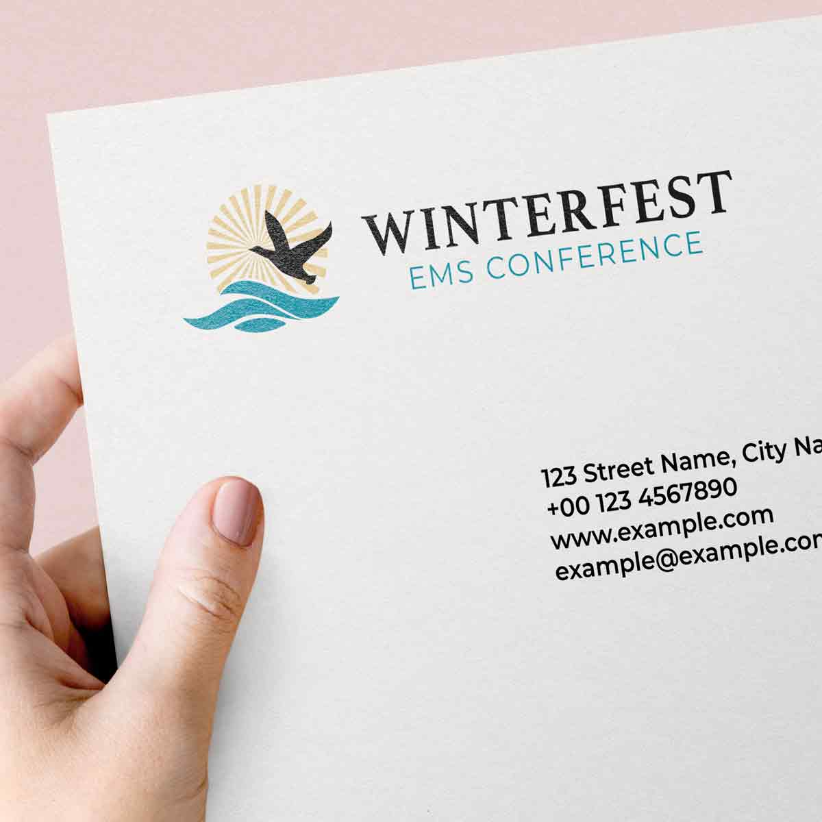 Someone holding a piece of paper with an address listed and the colored Winterfest logo
