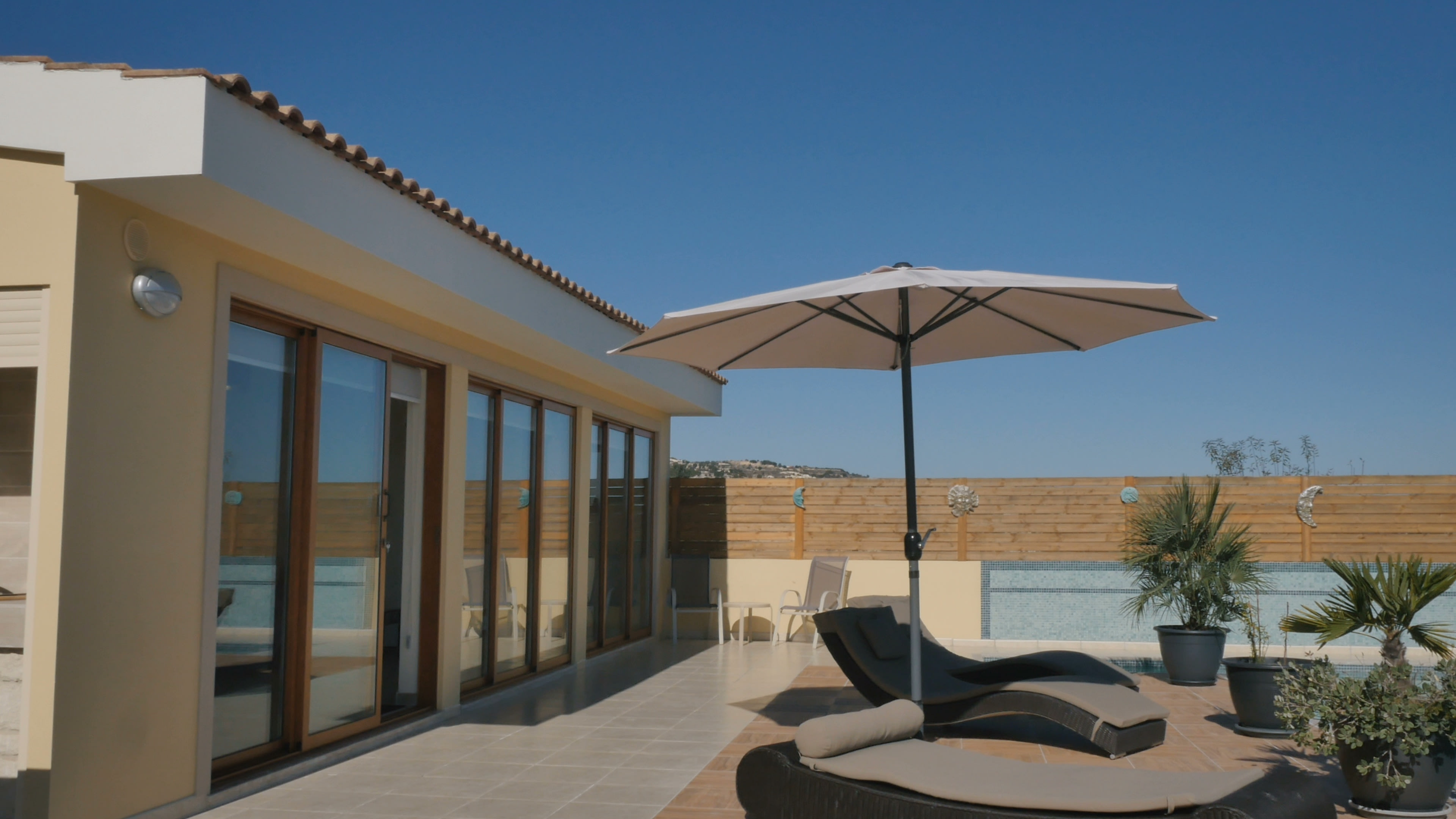 Umbrellas and deck chairs around the swimming pool