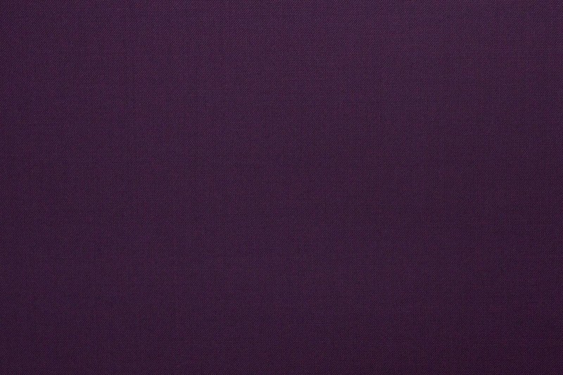 Detailed close-up of royal purple wool blend suiting fabric showing smooth texture, fine weave, and luxurious tailoring finish.