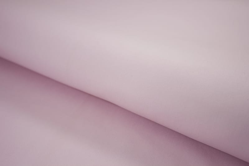 Close-up of rose pink wrinkle-resistant cotton shirt fabric