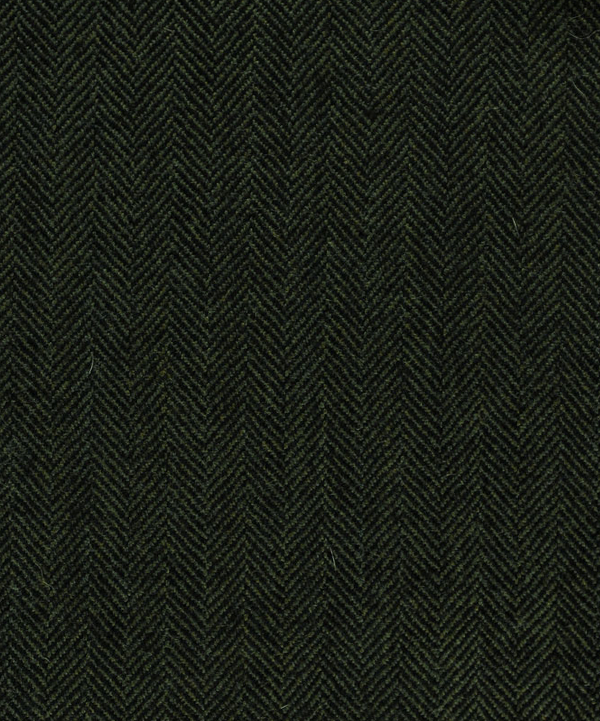 Detailed close-up of olive herringbone 100% wool tweed fabric