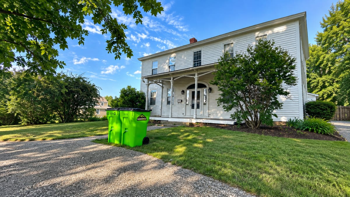 AGH green curbside bin in front of a house