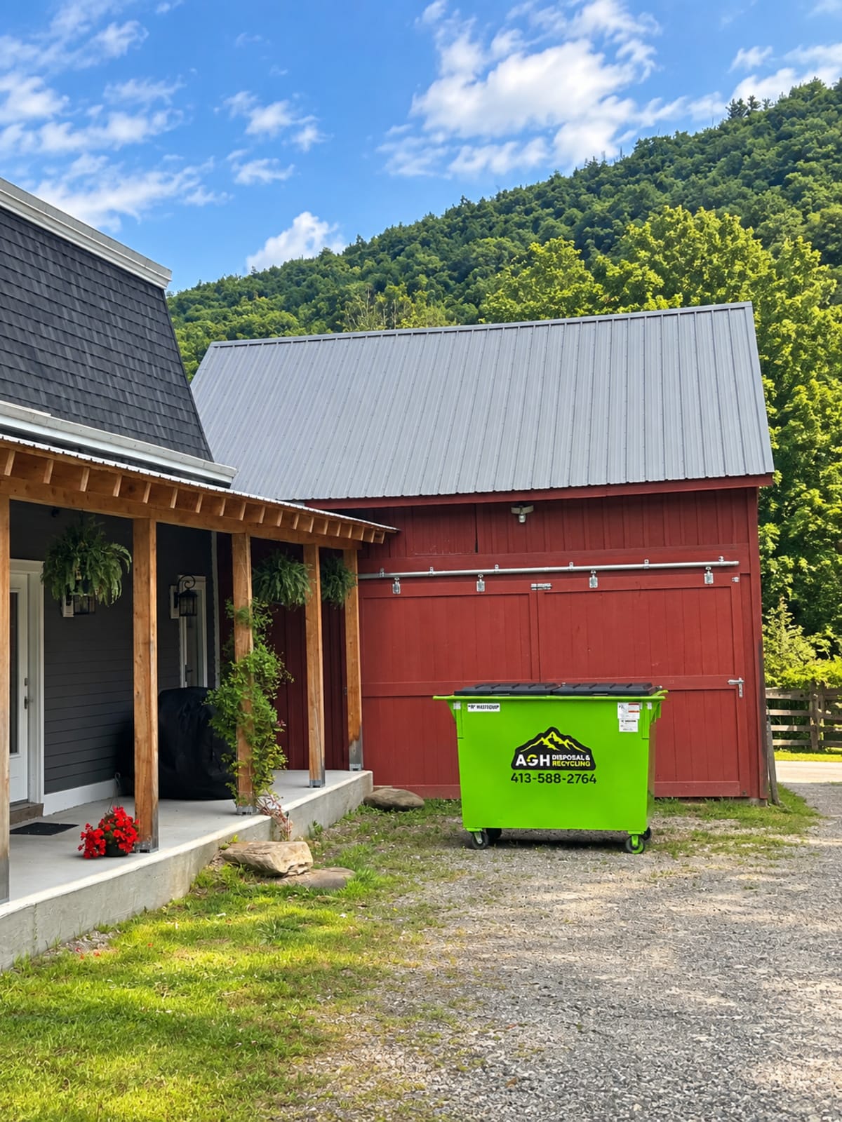 AGH green bin beside a red barn home