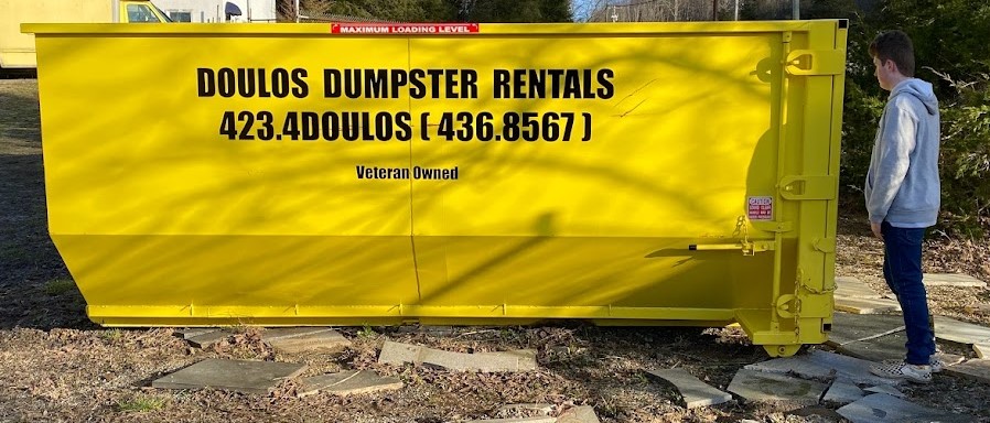 Doulos roll-off dumpster on a residential driveway in the Tri-Cities Tennessee area