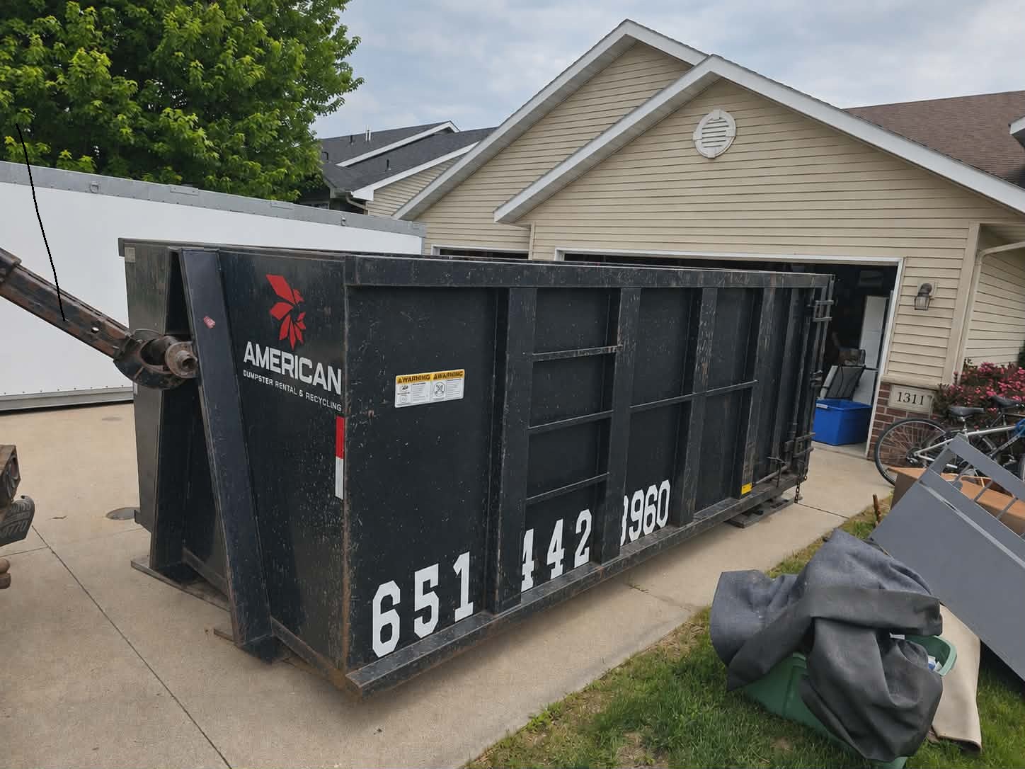 Roll-off dumpster rental placed in a residential driveway in the South Metro, Minnesota