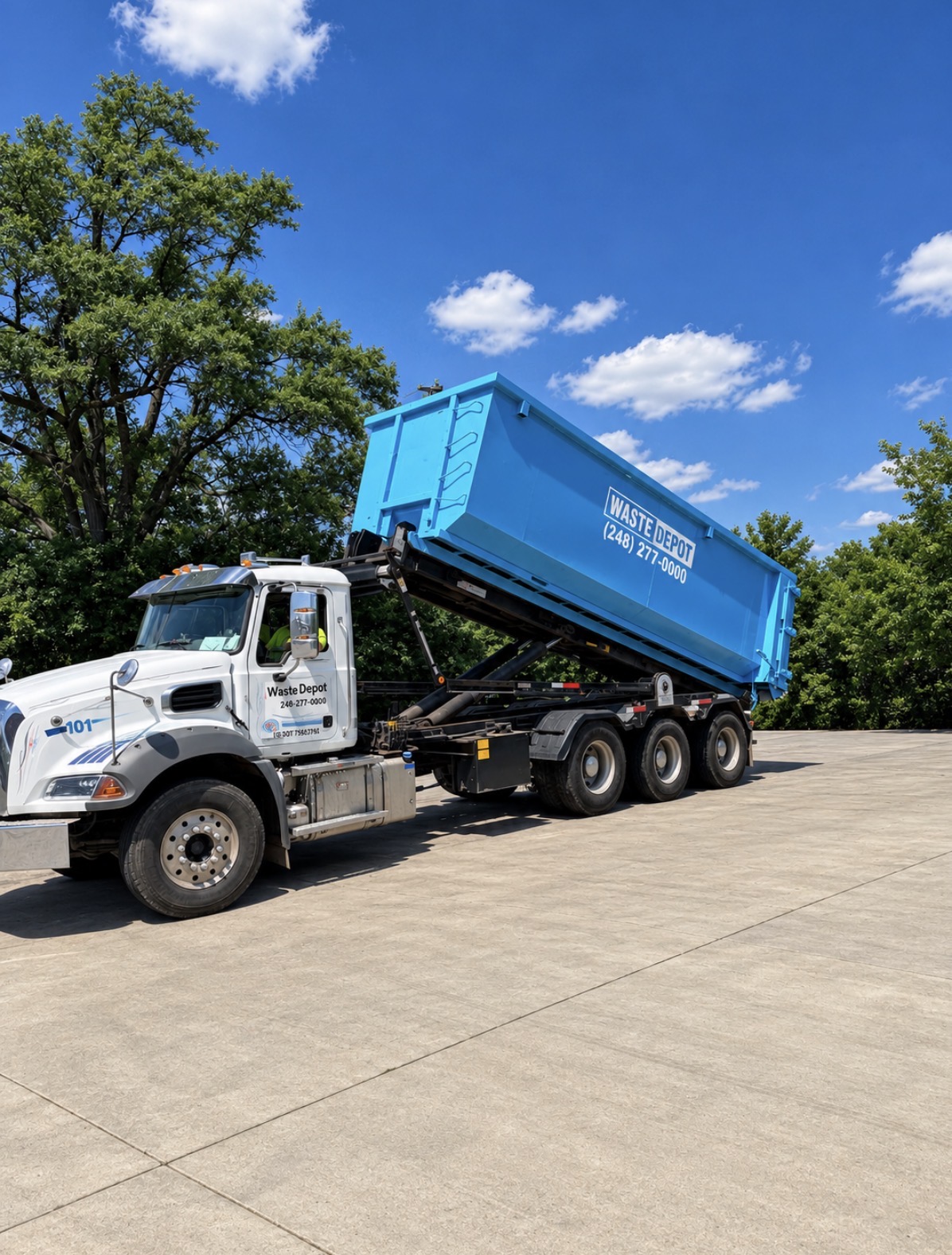 Waste Depot roll-off truck delivering a blue dumpster