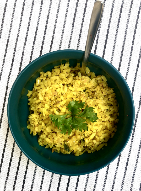 A popular Indian breakfast dish, made in Maharashtrian-style, using flattened rice, herbs, onions, and spices