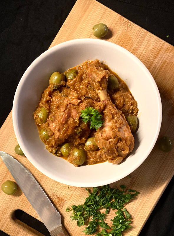 This recipe is a traditional Moroccan dish of chicken braised with spices, garlic, onion, olives, and lemon juice. Chicken is slow-cooked with green olives to create a burst of flavors which is enhanced by parsley. Pair with rice/bread or naan