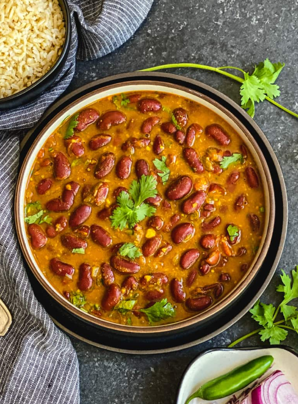 This Rajma recipe is a lightly spiced, creamy, and delicious Punjabi-style curry made with protein-rich kidney beans, aromatics like onions, ginger, garlic, fragrant spices, and tangy tomatoes. Pair with rice/roti