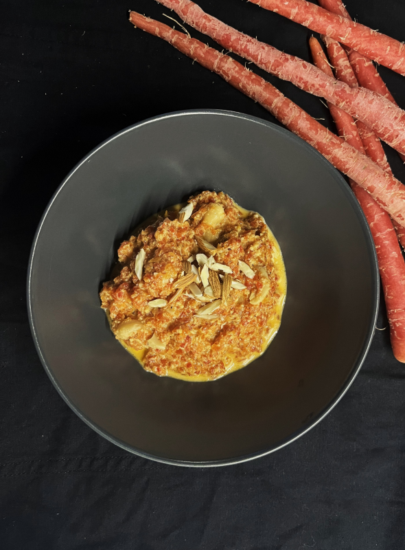 Gajar ka halwa is a popular Indian dessert made from grated carrots cooked in milk, khoya, and sugar, laced with cardamom, and garnished with nuts