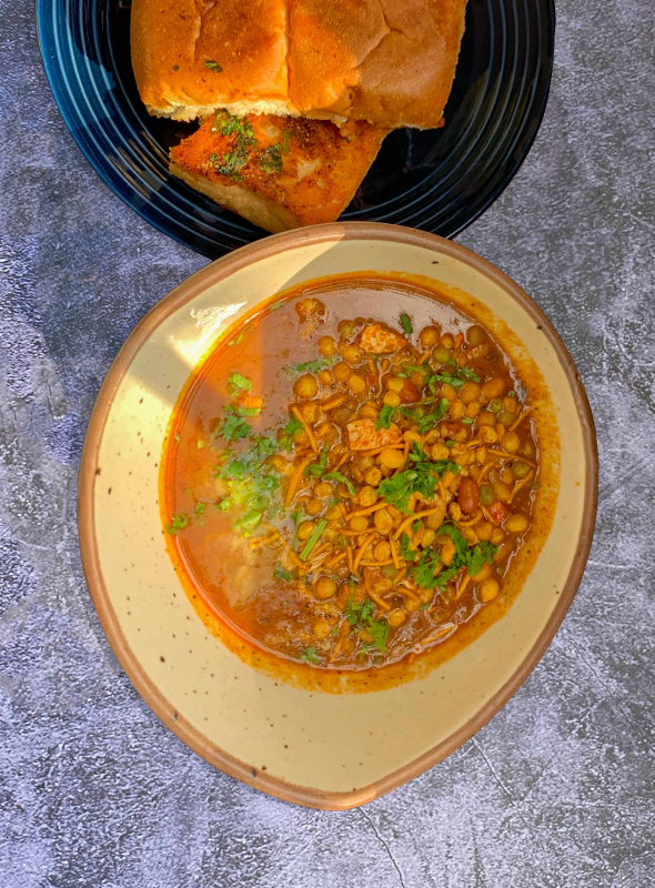 A much-loved Maharashtrian curry that is a spicy melange of potatoes, spices, and sprouted beans. Pair with Pav
