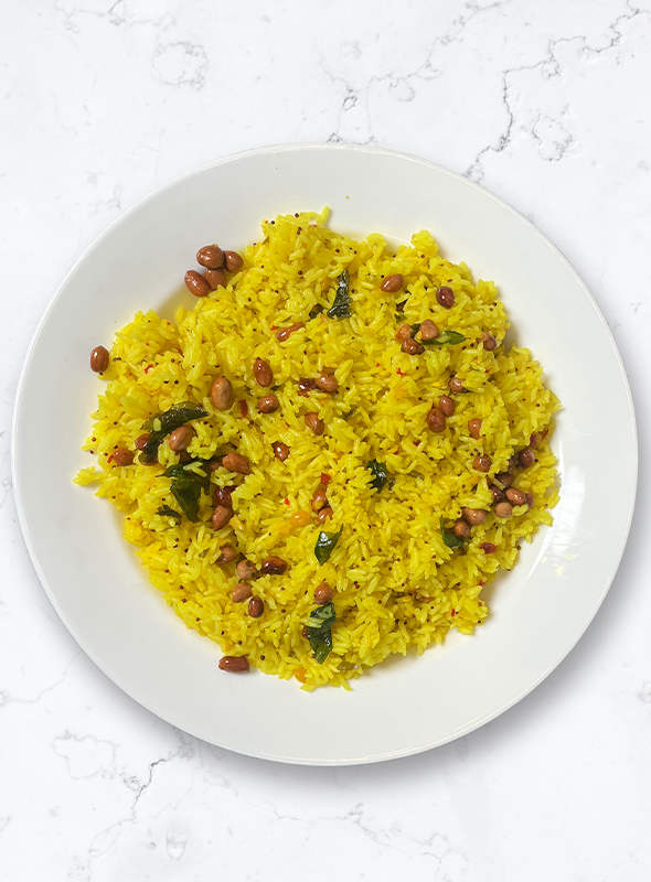 Raw mango chitrana is a popular South Indian rice dish that is prepared with cooked rice, grated raw mango, and a mixture of spices and seasonings. The dish is typically tangy, spicy, and flavorful, and is often served as a main course or as a side dish. Pair with Chutney