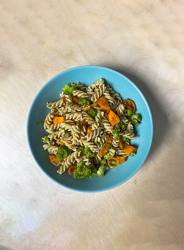 A simple and healthy pasta dish prepared using a steamer basket method. Steaming the vegetables helps retain their nutrients while providing a lighter and slightly different texture compared to traditional boiling methods